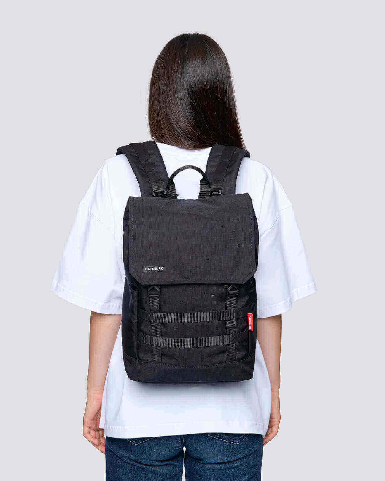 Stylish black Minato Lite backpack shown on a model, perfect for everyday use and weekend adventures.
