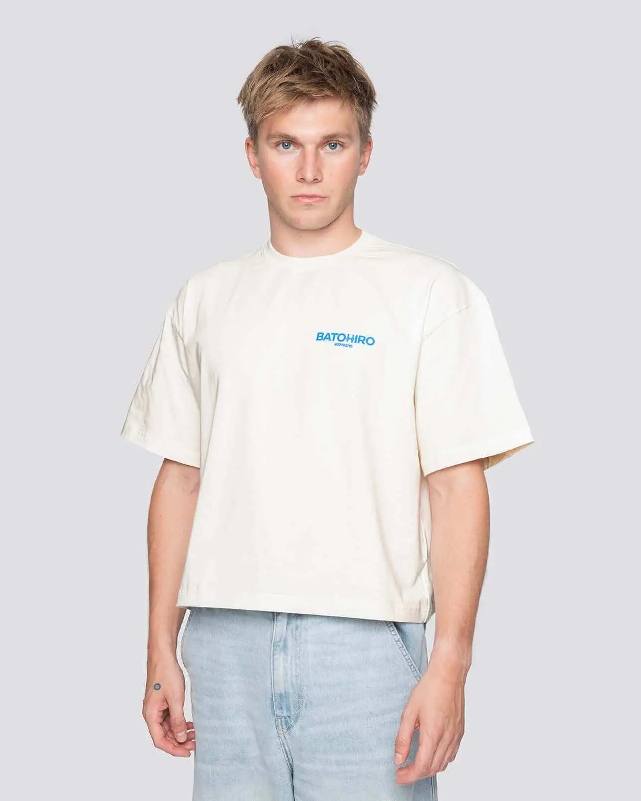 Model in cream cropped oversized Batohiro t-shirt, showcasing its unique design and comfy fit.
