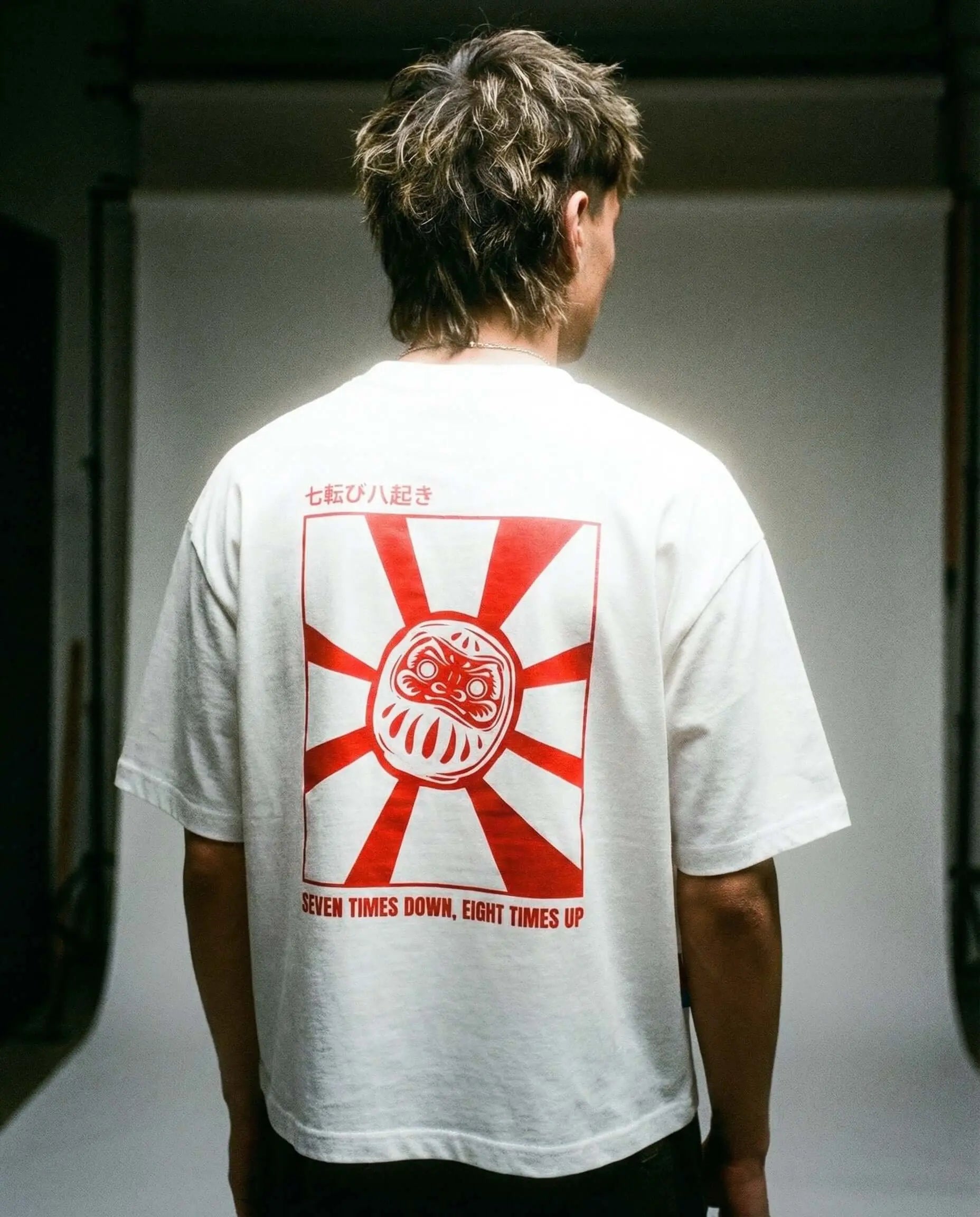 Daruma - White Cropped Oversized Tee - Model wearing tee with Daruma graphic and red sun design on the back.