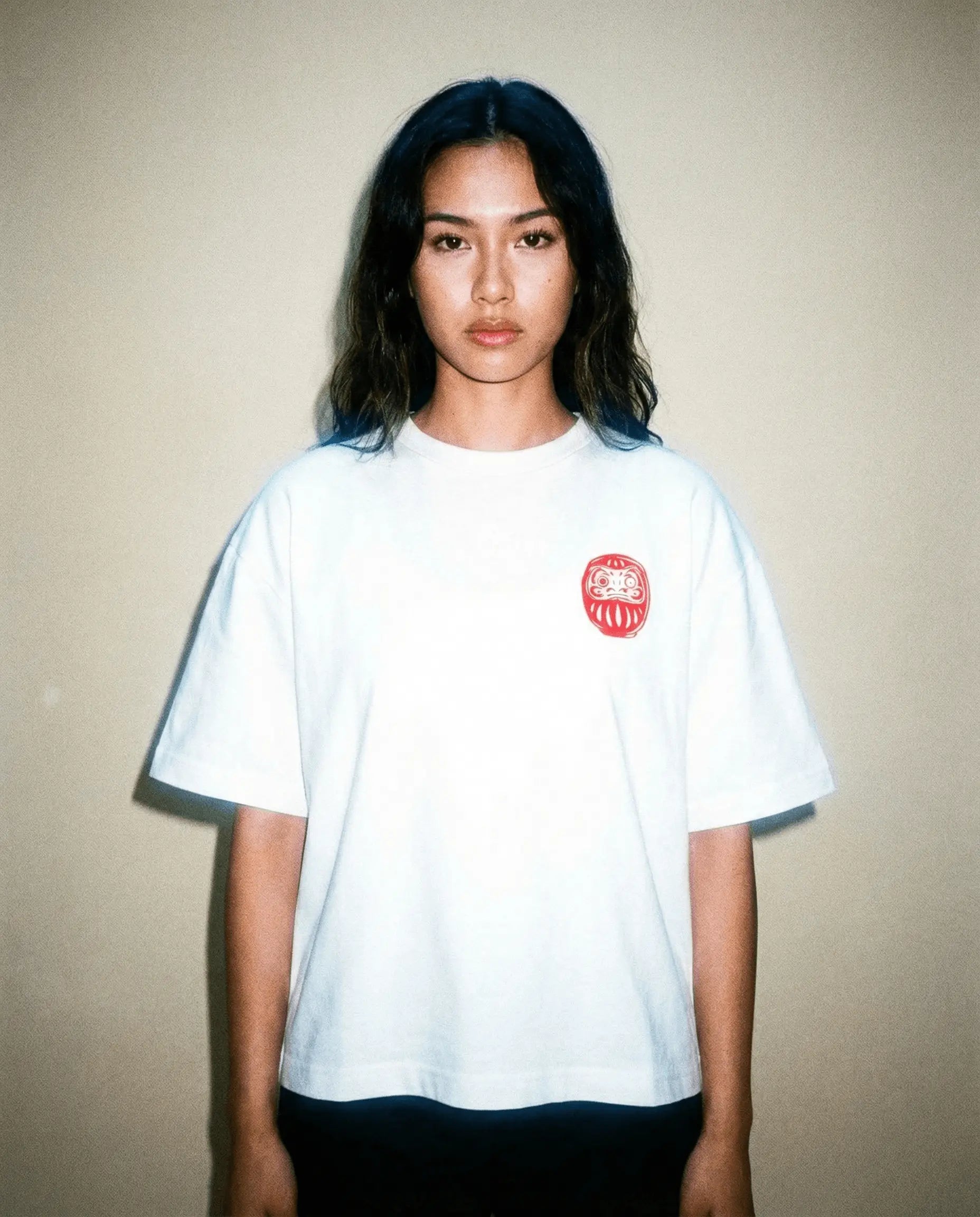 Daruma - White Cropped Oversized Tee worn by a model with a red embroidered design.