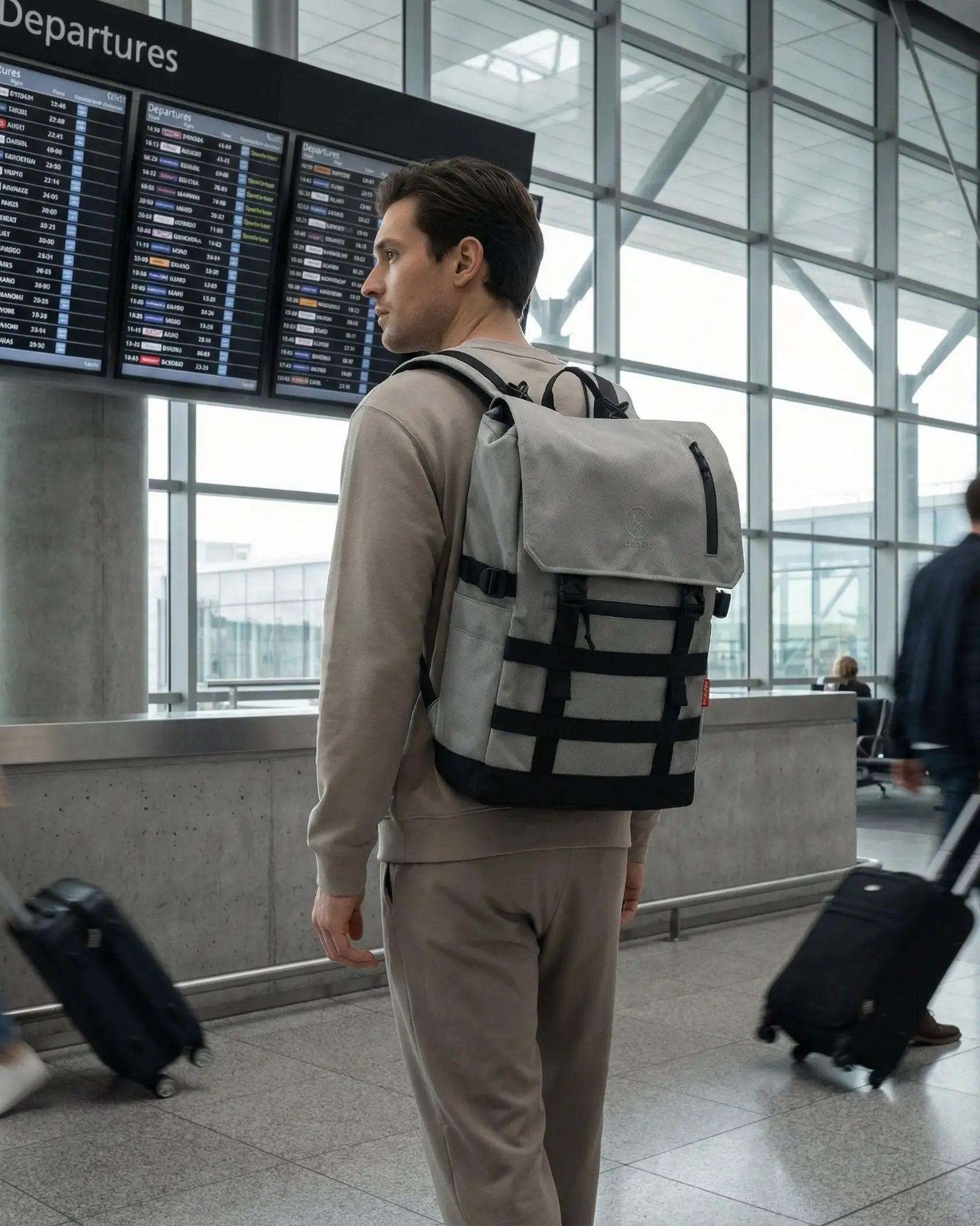 Minato Premium 6.0 – Silver backpack in an airport setting, showcasing its durable CORDURA® 1000D fabric.